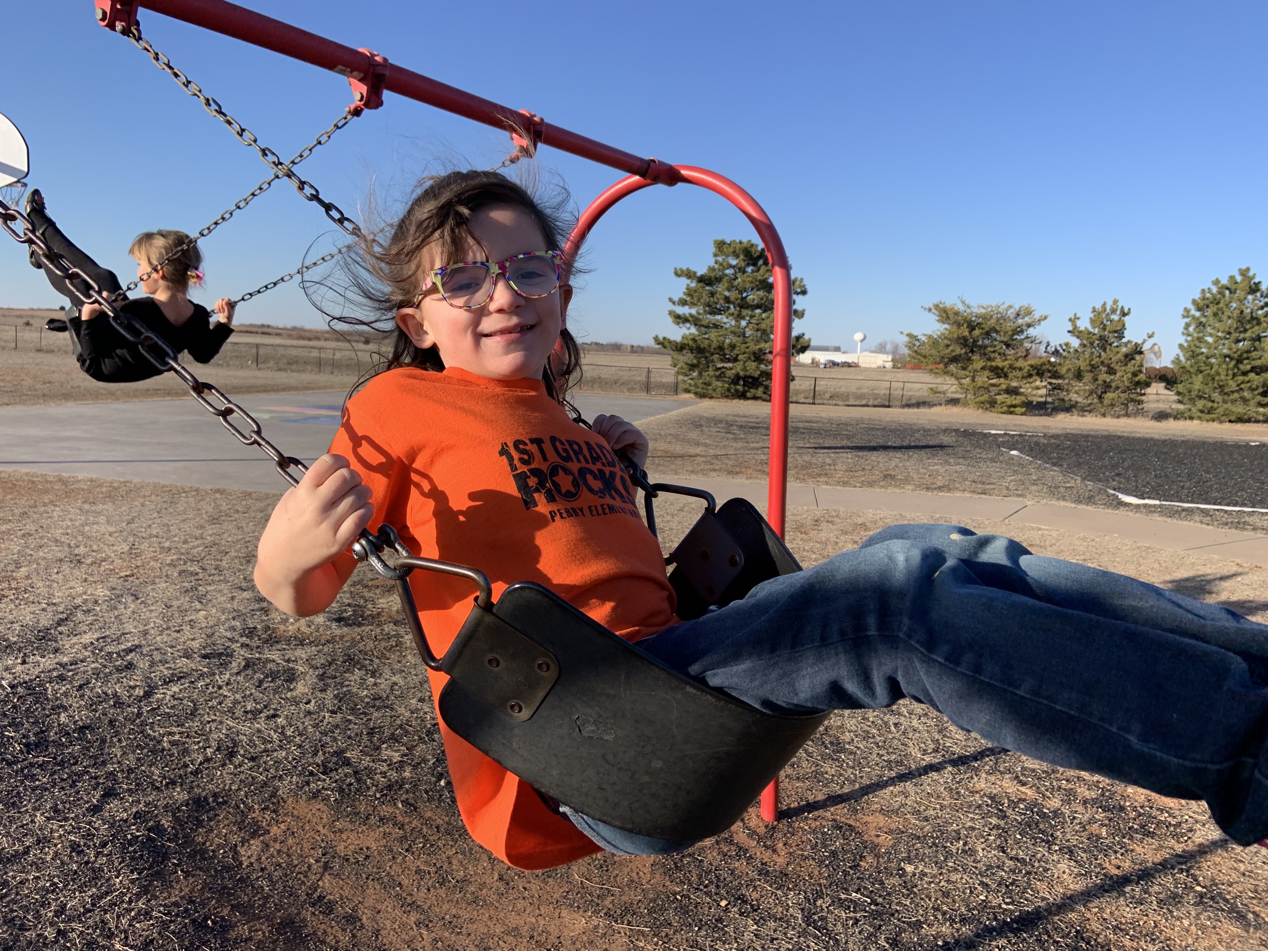 smiling child on a swing